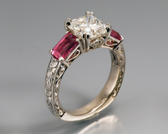 “Dream Cushion” diamond, with vivid hot pink spinels set in 18k white gold hand engraved engagement ring